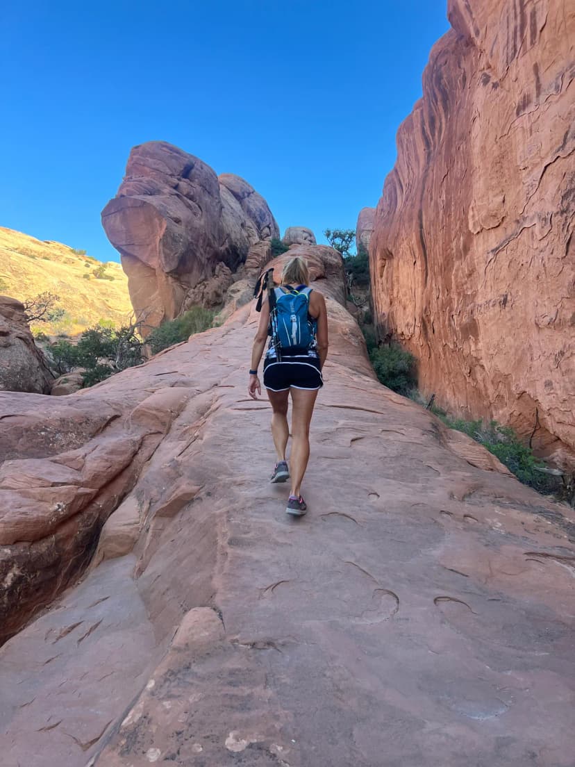 Stephanie hiking in a red rock canyon