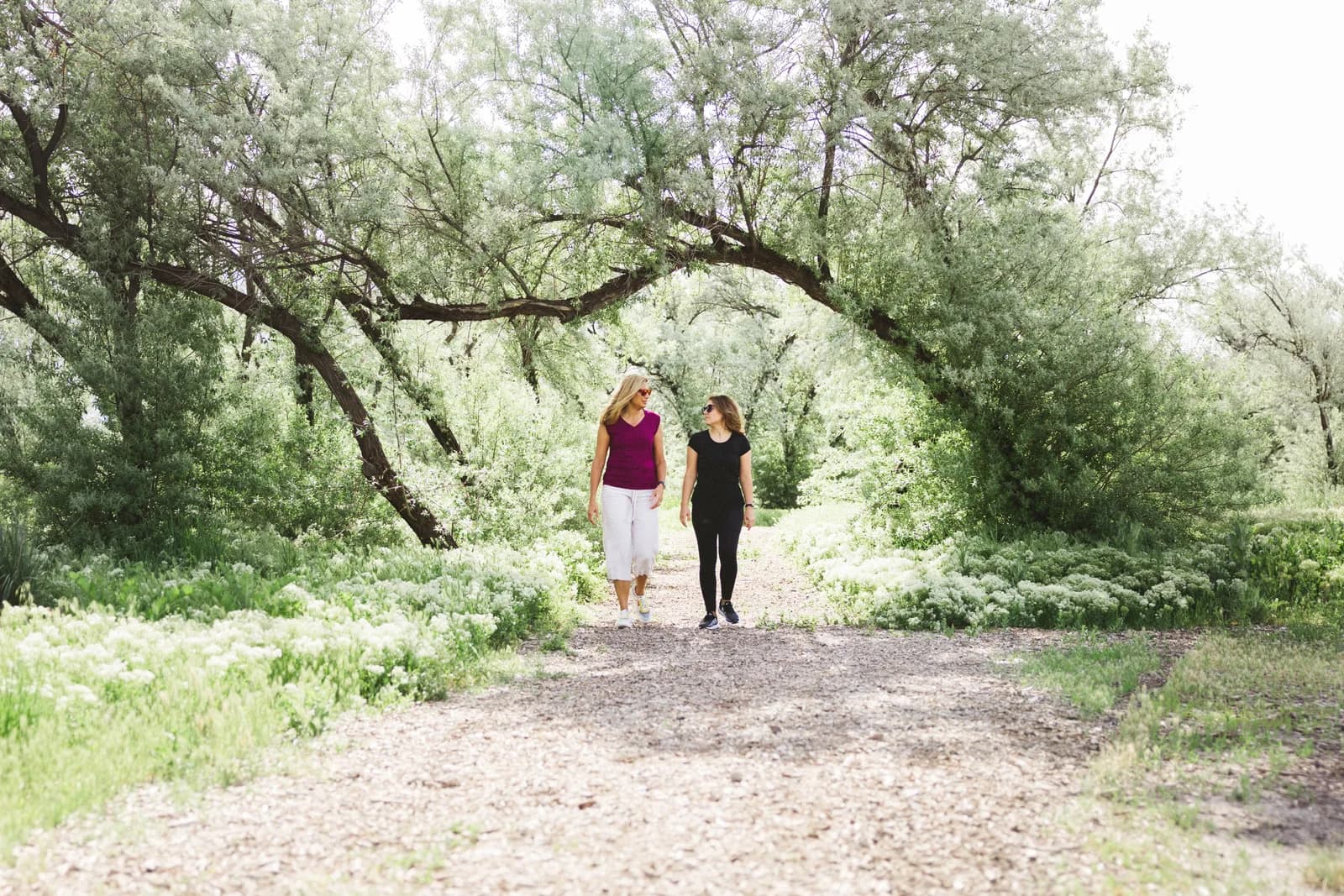 Stephanie Schmid walking with a client on a forest path